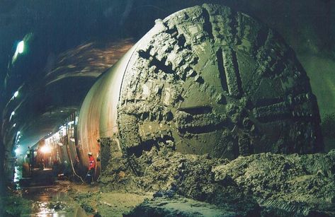 A tunnel boring machine (TBM), also known as a "mole", is a machine used to excavate tunnels with a circular cross section through a variety of soil and rock strata. They may also be used for microtunneling. They can bore through anything from hard rock to sand. Tunnel diameters can range from one metre (3.3 ft) (done with micro-TBMs) to 17.6 metres (58 ft) to date. Atheism Humor, Tunnel Boring Machine, Construction Machines, Cross Section, Cloud Gate, Mole, Hard Rock, Engineering, Travel