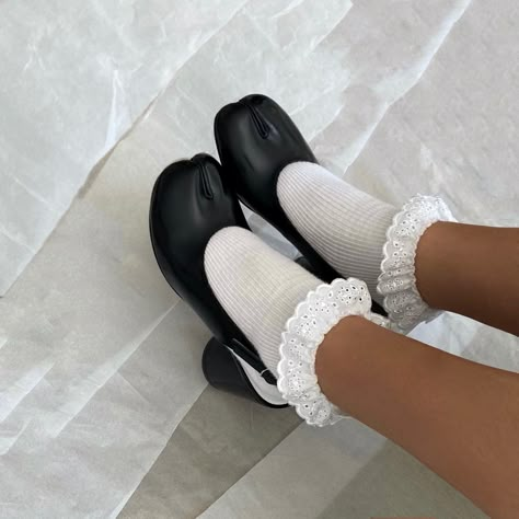 black tabi boots worn with white lace socks margiela tabi boots instagram fashion archive tabi heels tabi sandals Black Tabi Boots Outfit, Tabi Slingback Outfit, Tabi Sling Back, Tabi Shoes Aesthetic, Tabi Heels Outfit, Tabis Margiela, White Tabi Boots Outfit, Tabbies Shoes, Socks With Shoes