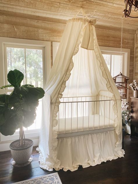 Transform your nursery into a dreamy space with our gorgeous and enchanting ivory crib canopy with a soft ruffled detailing down the inside leading edges, a full ivory gathered crib skirt, and a large crib bow in ivory to place around the front and center of the canopy. Our creamy ivory crib canopy set for baby boys and baby girls is graceful and elegant. Handcrafted by a small team of talented seamstresses in our Alabama studio, we know you’ll love this ruffled canopy set for many years to come Nursery Canopy, Dreamy Space, Crib Canopy, Farmhouse Nursery, White Canopy, Dream Nurseries, Crib Skirt, Nursery Room Design, Baby Room Inspiration