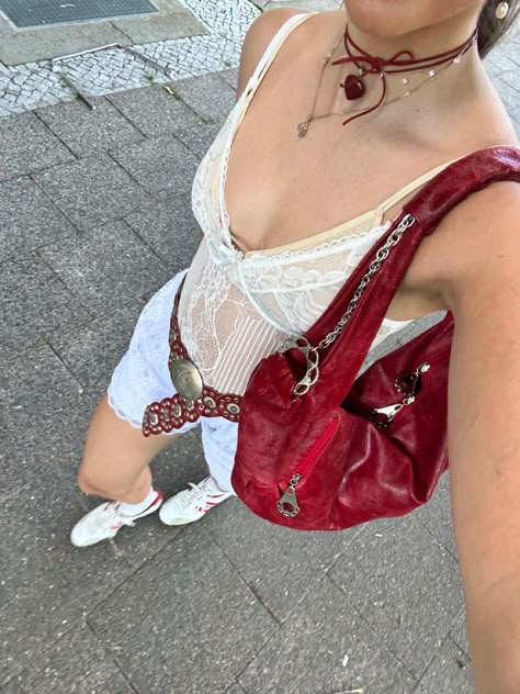 Close up picture from above of girl walking in the streets wearing a white sheer lace top, white lace shorts, red concho belt, red shoulder bag, heart stone leather band necklace, white soccer sneakers with red stripes. Red Accessories Outfit, Cloth Belts, Red Bag Outfit, Lace 2023, Red Top Outfit, Concho Belts, Red And White Outfits, Concho Belt, Hippie Wallpaper