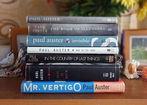 Paul Auster's novels explore the postmodern condition, the "feeling of time running out" and the fragmentary nature of modern society. His work is often categorized as part of the literary genre of magical realism or postmodern literature. #paulauster #metafiction #travelsinscriptorium #thebookofillusions #invisible #maninthedark #inthecountryoflastthings #handtomouth #mrvertigo #books #bookstagram #bookstagrammer #bookreview #booklover #bookrecommendations #bookaddict #booknerd #booktok Book Piles, Modernism In Literature, Postmodern Literature, Penguin Classics Clothbound, Magical Realism Books, Paul Auster, Penguin Modern Classics Covers, Literary Genre, Magical Realism