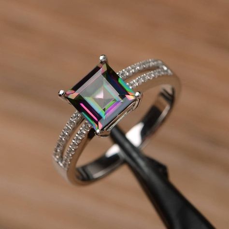 It is a mystic topaz ring. The main stone is 7mm*7mm square cut, weight about 2.31 carats. The basic metal is sterling silver and plated with rhodium. To change the metal to a solid gold (white/rose) or platinum is also available, please ask for a quotation if you want. You can also go to my shop Wedding Ring Square, Rainbow Topaz, Mystic Topaz Ring, Ring Square, Flower Engagement Ring, Rainbow Gemstones, Silver Wedding Rings, Mystic Topaz, Ring Promise