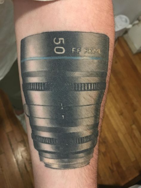 Profile of a 50mm camera lens. My first and only tattoo (so far) now a little over a year old. All credit to Josh Grable at Speakeasy Tattoos in Chicago. Leica Camera Tattoo, Camera Tattoos For Men, Lens Tattoo Camera, Canon Tattoo Cameras, Photography Tattoo Ideas Cameras, Speakeasy Tattoo, Camera Lens, A Year, Year Old