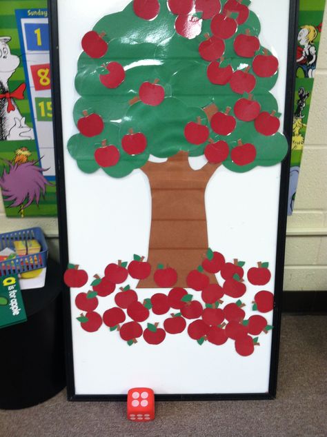 This is a fun game my students love to play during apple season... and it helps with counting skills too! I made a large tree out of construction paper and had it laminated along with around 60 apples that were also laminated. I attach all the apples to the tree using tape (I will replace the tape with velcro dots as soon as I can). Then each child takes a turn rolling a large foam die. They count the dots on top to see what number they rolled then remove that many apples from the tree. Pin The Apple On The Tree Game, Tree Out Of Construction Paper, Apples Activities, Apple Tree Activity, Tree Unit, Apple Week, Baby First Birthday Themes, Sensory Wall, School Board Decoration