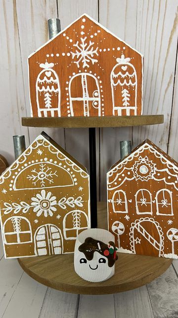 Tina💋Paper Crafter & Maker on Instagram: "Gingerbread houses DIY These house were last years @target dollar spot and I needed some cute gingerbread houses to add to my cocoa bar this year so I made them myself. Used three different color of brown paints and then a pencil to draw my design and a very fine @posca_usa pen and white fabric paint…that fine line of the posca pen really added the detail and covered up mistakes. This would be fun to do with kids or for a church group. #happycraft Painting Wooden Gingerbread Houses, Wooden Gingerbread House Diy, Diy Wooden Gingerbread House, Brown Paper Gingerbread House, Painted Gingerbread Houses, Plywood Gingerbread House, Folk Art Gingerbread House, Gingerbread Houses Diy, Cute Gingerbread Houses