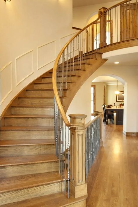 Wooden Curved Staircase, Curved Staircase Remodel, Under Curved Stairs Ideas, Curved Staircase Makeover, Curved Staircase Wall Decor, Curved Staircase Foyer Entryway, Wood Floor Alternative, Curved Staircase Ideas, Curved Staircase Foyer