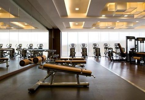 Love the use of the tan leather / vinyl on the fitness equipment for a warmer, luxury feel. Ceiling Accents, Fitness Interior, Fitness Center Design, Luxury Fitness, Gym Design Interior, Luxury Gym, Gym Club, Unique Dining Room, Basement Gym