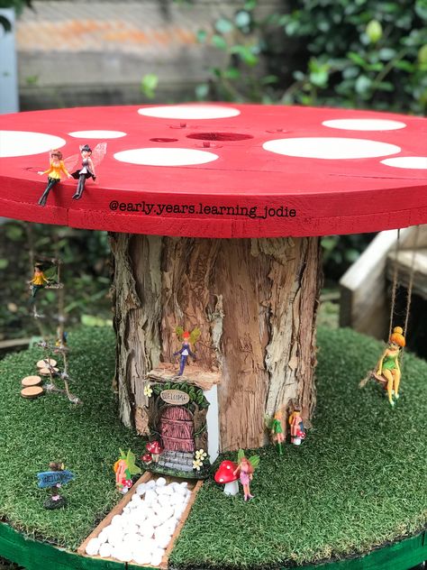 I picked up the reel for $20 on Gumtree and absolutely loved creating this gorgeous fairy garden 🍄🧚‍♀️ Fairy Garden Cable Reel, Childminder Garden Ideas, Cable Drum Fairy Garden, Electrical Reel Ideas, Wooden Spool Fairy Garden, Wooden Cable Reel Ideas, Cable Reel Fairy Garden, Cable Reels Eyfs, Fairy Garden Eyfs