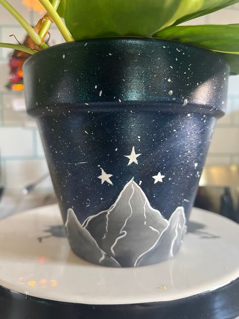 Great Planter for any book lover or Acotar lover, booktok,  Velaris City Of Starlight, City of Starlight planter ACOTAR    painted by hand  Every pot is unique  The full pot is painted with the night sky Mountains are in the front of the planter  Comes in 6inch and 4 if requested  Saucer not included Velaris Acotar Painting, Acotar Craft Ideas, Velaris Painting Easy, Acotar Pottery, Acotar Room, Acotar Painting Ideas, Funny Pottery Painting Ideas, Acotar Crafts, Acotar Diy