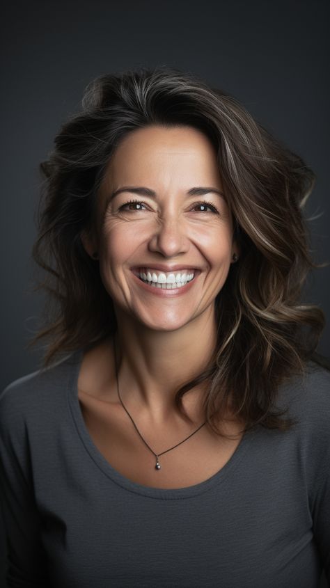 portrait of an average, middle aged female, looking direct to camera. Relaxed, natural laughing smile, olive skin and light brown hair that is slightly messy, grey background Brown Hair Middle Aged Woman, Older Women Dark Hair, Middle Aged Woman Brown Hair, Older Women Character Inspiration, Middle Aged Portrait, Middle Aged Brunette Woman, Older Woman Brown Hair, Older Women Headshots, Middle Age Haircuts For Women