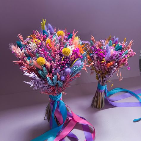 Introducing our Vibrant Dried Flower Bouquet, a top-seller renowned for its stunning array of colors, primarily featuring rich shades of purple, blue, and pink with berry undertones. This bouquet is an ideal choice for couples seeking a bohemian, whimsical, or LGBTQ+ pride-themed wedding, as well as those embracing a bright and colorful wedding palette. 🌈 Our bouquet showcases a lively assortment of premium dried flowers carefully selected and artfully arranged to create a breathtaking visual d Nontraditional Bouquet Wedding, Creative Wedding Bouquets, Dry Flower Wedding Bouquet, Color Wedding Bouquets, Rainbow Wedding Centerpieces, Rainbow Flower Bouquet, Wedding Bouquets Colorful, Colorful Wedding Palette, Purple Spring Wedding