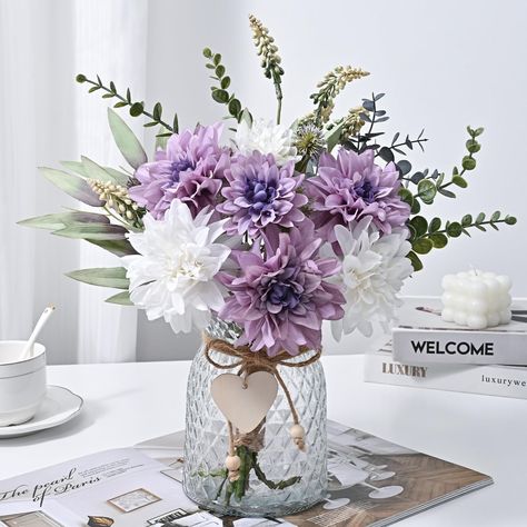 PRICES MAY VARY. FULL OF CLEAN & CLASSIC ACCENT-3 white dahlia and 4 purple dahlia bring out the best in each other, making the whole artificial flowers in vase full of clean vibe. The translucent thick vase has a nice texture on the glass, and the little wooden heart tag also adds a delicate finishing touch. JUST THE RIGHT SIZE-Each bunch of flowers is 16” in length and each thick vase is 6” in height, tall enough that grab your attention when you see them but not too big that they take up a lo Purple Flower Centerpieces, Purple Table Settings, Dahlias Flower, Dahlia Flower Arrangements, Purple Flower Arrangements, Fabric Daisy, Purple Wedding Centerpieces, Home Flower Arrangements, Flower Table Decorations