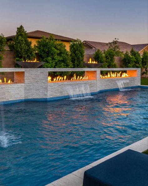 Modern Pool With Fire Feature, Fire Features Pool, In Ground Pool Water Features, Modern Pool With Waterfall, Pool Waterfall Wall Tile, Desert Pool Ideas, Sloped Hardscape, Modern Pool Waterfall, Rectangular Pool Landscaping