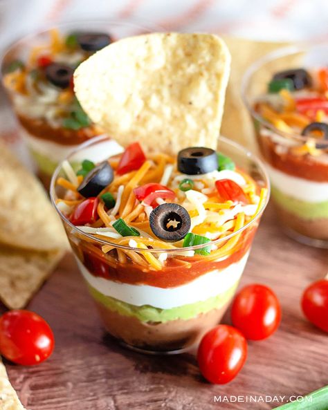 Looking for a finger food recipe for your next party? This recipe for Classic Mexican 7 Layer dip served as individual appetizers in cups is the perfect solution. 7 layer dip in cups, appetizers in a cup, mini appetizers in cups, 7 layer dip in a cup Appetizers In Cups, 7 Layer Dip Cups, Mexican 7 Layer Dip, Layered Dip Cups, Copycat Recipes Desserts, Taco Cups Recipe, Dip Party, Appetizer Cups, Layered Taco