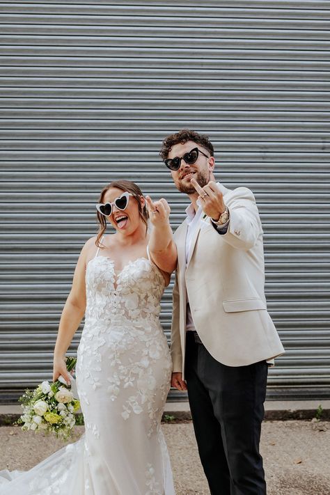 The bride and groom wearing black matching sunglasses show off their wedding ring finger with their new wedding bands Wedding Ring Finger Flip Off, Ring Finger Photo, Wedding Sunglasses Picture, Sunglasses Wedding Photos, Matching Sunglasses, Disco Ball Decor, Downtown Elopement, Couture Bridesmaid Dresses, Monochrome Wedding