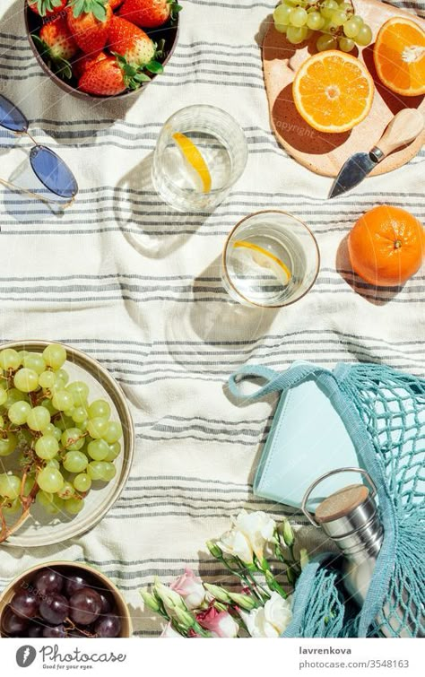 Summer picnic flatlay, fruits, berries and lemon water on striped cotton blanket - a Royalty Free Stock Photo from Photocase Summer Flatlay Photography, Picnic Product Photoshoot, Picnic Product Photography, Picnic Flatlay, Goop Kitchen, Picnic Candles, Summer Picnic Aesthetic, Summer Still Life, Product Flatlay