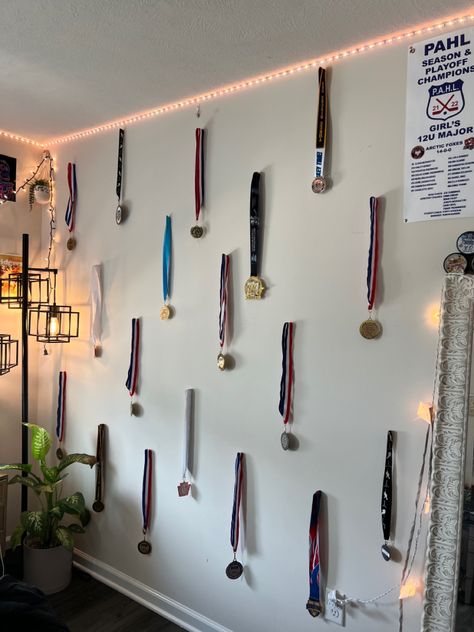 i turned my medals into a pintrest inspired wall that is perfect for my room. all medals are my own from hockey! Medal Display Aesthetic, How To Decorate Medals In Room, 1st Place Medal Aesthetic, Medals Aesthetic, Medal Design Ideas, Dance Medals, Karate Medal Display, Display For Medals And Ribbons, Hanging Medals