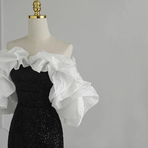 This gothic black and white wedding dress is sure to stand out from the rest. It is adorned with sequins and a ruffle that cascades down the front. The fit is flattering for all body types and the dress is sure to make a statement. ❤️CUSTOM MADE❤️ For custom made, please message us your height, bicep circumstance, bust, lower chest circumference, mid-shoulder to bust point, waist and shoulder width. How to measure? Black And White Evening Gown, Black And White Wedding Dress, Black And White Prom Dresses, White Evening Gown, Masquerade Outfit, Plus Size Formal Dress, Black And White Gown, Dress Outfits Party, White Evening Gowns