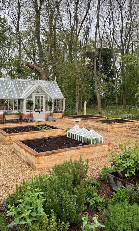 A gardeners dream with devine green house and planters Garden Area With Greenhouse, Greenhouse Surrounded By Garden, Kitchen Garden With Greenhouse, White Green House Aesthetic, Raised Bed Garden With Greenhouse, Green House In Garden, Beautiful Green Houses, Green House Asthetics, Greenhouse With Raised Beds