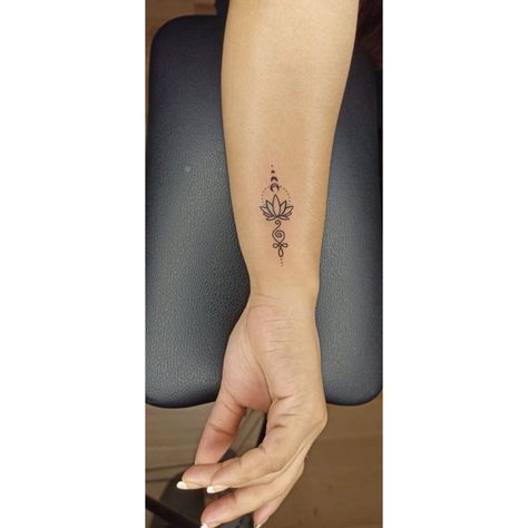 The symbol of goddess Laxmi to bring wealth and prosperity to your life. This beautiful lotus and half-moon tattoo are very simple and unique styled. It will give you positivity about life and your personality. Call +91-9958499420 #BesttattooartistinDelhi #BestTattooArtistInNoidaSector15 #besttattooshopinNoidA #besttattooshopnearme #lotustattoo #lotustattoodesigns #tattooshopnearmeinnoidaghaziabad Hindu Wrist Tattoos For Women, Prosperity Tattoo Design, Om Tattoo Design For Men, Laxmi Symbol, Om Tatoos Design, Laxmi Tattoo, Lotus Wrist Tattoos For Women, Lotus Om Tattoo, Minimalist Lotus Tattoo