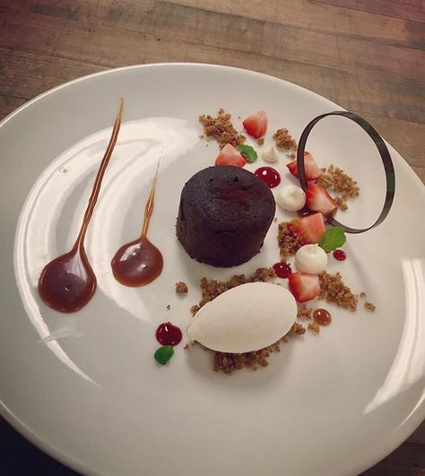 It's #nationaldessertday so here's my chocolate lava cake from Plated Desserts filled with strawberry ganache with caramel sauce, pink peppercorn gelato, raspberry coulis, meringue kisses, pink peppercorn graham cracker crumbs, fresh strawberries and tempered chocolate ring . . . . . #dessert #plateddessert #food #foodporn #jwu #icecream #chocolate#pastry #imadeitatjwu Yummery - best recipes. Follow Us! #foodporn Strawberry Ganache, Tempered Chocolate, National Dessert Day, Fine Dining Desserts, Raspberry Coulis, Chocolate Strawberry Cake, Meringue Kisses, Dessert Presentation, Pink Peppercorn