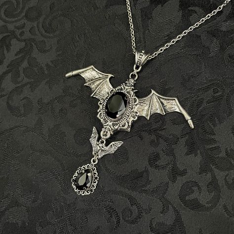 "This hauntingly beautiful Gothic Vampire Bat necklace features richly detailed antiqued silver toned open winged bats and filigrees. They are adorned with dazzling Jet Black glass jewels.  Pendant is 4\" inches tall including the bail, and is 3 3/4 inches wide.   You have the option to choose soldered stainless steel chains, or a polyester black ribbon choker. Each closes with a lobster clasp and chain extender so you can adjust the length as needed. If you would like a different length than what is listed, please send us a message. Matching earrings are listed separately in our store. If you would like this design in a different stone color, feel free to ask about availability." Black Ribbon Choker, Victorian Gothic Jewelry, Vampire Jewelry, Bat Necklace, Goth Necklace, Ribbon Choker, Victorian Necklace, Edgy Jewelry, Gothic Vampire