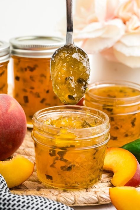 Peach Jalapeno Jam is a sweet and spicy condiment that can be used to enhance a variety of dishes! This homemade recipe uses fresh juicy peaches and jalapenos. It’s a super easy crowd-pleaser. via @2kitchendivas Jalapeño Peach Jelly, Peach Jalapeño Pepper Jelly Recipe, Hot Peach Jam, Peach Habanero Jam Recipes, Peach Jalapeno Freezer Jam, Jalepeno Peach Freezer Jam, Small Batch Peach Jalapeno Jam, Freezer Jelly Recipes, Peach Jalapeno Jam Recipes