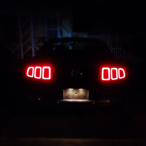 The rear tail lights of my 2013 Ford Mustang at night. Mustang Tail Lights, Mustang At Night, Mustang Night, Chiron Aesthetic, Bugatti Chiron Aesthetic, 2013 Mustang Gt, Mustang Tattoo, Mustang Headlights, Bugatti Centodieci