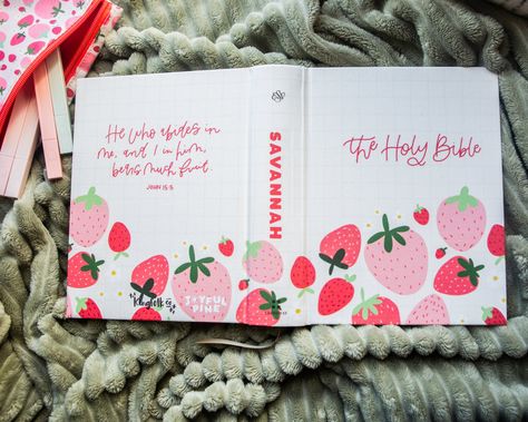 This strawberry designed Bible by Savannah at Joyful Pine is so very SWEET indeed! We love this Bible so much! It features a professionally printed cover - NO, not hand painted but PRINTED professionally in-house for the ultimate in quality and durability. You're going to LOVE this bible! + SPECS + + New Updated High Quality Hardboard with Fabric cover+ Single column, paragraph format, 7.5 font+ Crossway ESV Journaling Bible+ Cream-colored paper+ Ribbon marker+ 2" ruled margins for writing+ 6.25 in x 8.0 in+ Perfect size for taking to church+ Professionally printed in-house Please note that the spine will have a small gap in the print where the book bends. Since all our items are printed in-house, there might be a slight difference between the product preview and the finished printed resul Decorated Bible Cover, Simple Crafts To Sell, Painted Bible Cover Ideas, Bible Painting Cover, Bible Cover Ideas, Painting Bibles, Painted Bible Cover, Paragraph Format, Painted Journals