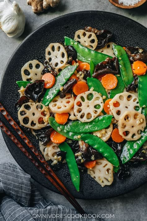 Stir fried lotus root, carrot, snow peas and wood ear mushrooms are tossed in a light savory sauce with a lot of garlic and ginger. It’s a dish that celebrates the spring. It’s super quick and easy to put together, making it the perfect side dish for your dinner. {Vegan, Gluten-Free Adaptable} Chinese Carrots, Fried Lotus Root, Lotus Root Recipe, Vegan Stir Fry, Cantonese Food, Cantonese Cuisine, Chinese Vegetables, Garlic And Ginger, Authentic Chinese Recipes