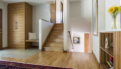 This 1958 split-level home featured a kitchen typical of its era - small and cut off from the rest of the home. In the traditional enclosed kitchen of these older houses, seating space is limited. Where the kitchen tends to be the place of the home for family gatherings and get togethers, an inviting, wide-open floor plan became the solution. The addition of a three-season screened back porch presented a design challenge, requiring a variance from the city of Edina. The city appreciated the sens Tri Level Remodel, Split Level House Remodels, Tri Level House, Older Houses, Split Level Entryway, Enclosed Kitchen, Transitional Entry, Split Level Remodel, Architectural Design Studio