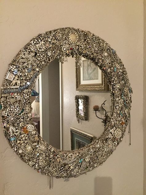 "Spectacular one-of-a-kind wall mirror created from thousands of pieces of authentic vintage rhinestone jewelry and other embellishments. I collected each jewelry piece over a period of 20 years and it took several years to finalize the arrangement of each and every item. Truly a labor of love and the end result is stunning!   *30\" diameter overall   *4\" wide frame   *20pounds   *hangs from single hanger Price reduced 11/22/2020." Vintage Mirror Wall Decor, Glam Mirror, Old Jewelry Crafts, Jewelry Frames, Vintage Rhinestone Jewelry, Jewelry Christmas Tree, Vintage Mirror Wall, Fashion Mirror, Jewelry Mirror