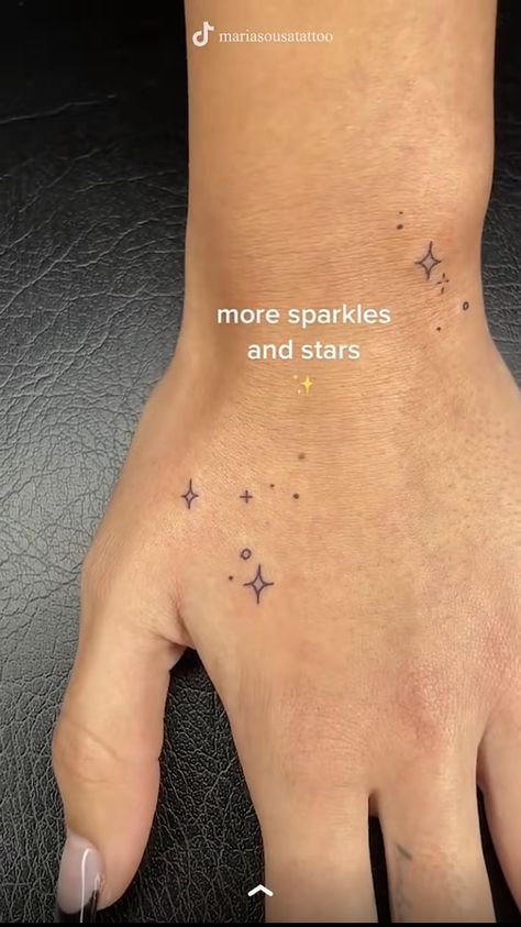 Sparkle Tattoos On Hand, Micro Arm Tattoo, Minimal Stars Tattoo, Ken Eurich Hand Tattoos, Galinda Tattoos, Tiny Star Hand Tattoo, Fairy Dust Tattoo Stars, Matching Sparkle Tattoo, Dainty Thumb Tattoos