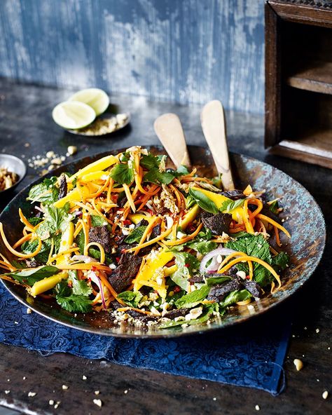 Transport yourself to Vietnam with every bite of this spicy beef salad. The sweetness from the mango and the crunch from the carrots help combat the heat from the marinade. Spicy Beef Salad, Beef Salad, Asian Salad, Spicy Beef, Mango Salad, Vietnamese Recipes, Asian Recipes, Beef Recipes, Salad Recipes