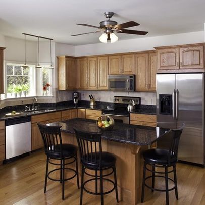 Oak Cabinets with stainless and white appliances and black countertop Kitchen Black Counter, Modern Walnut Kitchen, Walnut Kitchen Cabinets, Black Kitchen Countertops, Black Appliances Kitchen, Honey Oak Cabinets, Walnut Kitchen, Black Countertops, Traditional Kitchen Design