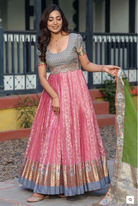 Kota Banarasi Silk Anarkali with Pethani Border and Maggam Worked Yoke Long gown for Festival occasion /partywear/ Wedding dress. Indulge in timeless elegance with this exquisite Zari Kota Banarasi Silk Anarkali. Crafted with intricate detailing and rich cultural heritage, this ensemble features a stunning Pethani border and meticulously hand-embellished Maggam work on the yoke. The puff sleeves add a touch of regal charm, while the delicate Net Dupatta drapes gracefully, completing the look. Wh Kota Anarkali Dress, Border Saree Dress Pattern, Banarasi Dress Pattern, Anarkali Dress With Saree, Kota Dresses Designs, Traditional Gown From Saree, Traditional Gown Designs, Silk Saree Gown Designs, Traditional Long Frocks Indian