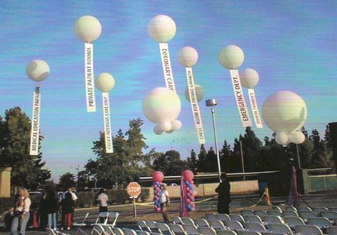 Giant balloons holding up signs Outdoor Events Decor, Halloween Block Party, Tent Decor, Balloon Release, Giant Balloon, Conference Event, Balloon Installation, Tent Decorations, Giant Balloons