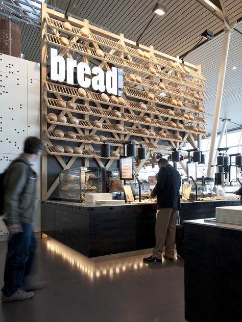 Travelers looking for last-minute gifts in Amsterdam's Schiphol airport need not venture far – a new space includes a cheese counter, bread shop, restaurant, plus flower store in one area.    Exuding a quintessentially Dutch vibe, the project is rooted in the culture and customs of the Netherlands, selling popular foods and products. Bread Display, Bakery Shop Design, Bakery Interior, Bread Shop, Food Retail, Retail Inspiration, Bakery Design, Bakery Shop, Retail Interior