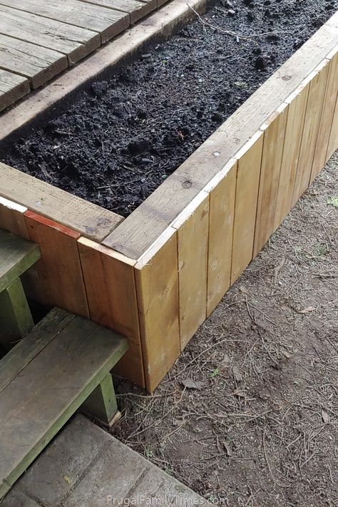 We designed and built this wood DIY deck planter to disguise the ugly edge of our deck and make the whole deck look bigger, with more style and feel safer. It worked really well - and only took an afternoon to build it! Here you will learn how to build a planter box for your deck with style and function and on a budget. Deck With Raised Garden Beds, Planters Around Deck, Deck With Plants, Building Planter Boxes, Deck Planter Boxes, Diy Wooden Planters, Diy Wood Planters, Deck Planters, Raised Planter Boxes