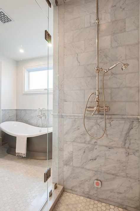 Walk-in shower featuring mixed gray marble shower tiles with marble chair rail tiles fitted with a vintage exposed plumbing shower kit enclosed by glass doors. Marble Chair, Marble Shower Tile, Bathroom Chair, Master Bath Renovation, Shower Plumbing, Shower Tiles, New House Bathroom, Marble Showers, Shower Floor Tile