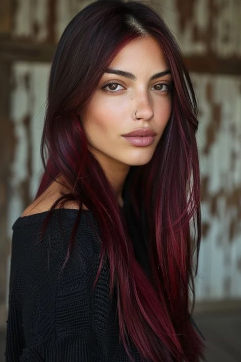 Young woman with long burgundy hair and subtle makeup looking at the camera. Dark Red Hair On Olive Skin, Wine Red Balayage Hair, Deep Red Balayage Hair, Red Hair With Brown Roots, Cool Red Hair Color, Light Red Highlights, Cherry Red Brown Hair, Red Hair Makeup Ideas, Red Hair Inspo Color