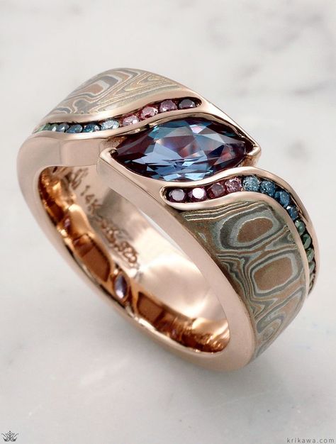 An organically shaped mokume band that is contoured to a variety of stone shapes.  The stone is flush set to the band, which thickens toward the top of the finger to allow for the depth of the stone.  Customized here with two channels of diamonds wrapping around both sides of the stone. The band is handcrafted in 14k rose gold with a 1.20ct Marquise Lab Alexandrite and a rainbow of Vivid Enhanced Color Diamonds. Jewelry Rings Unique, Cool Rings For Men, Stone Shapes, Modern Wedding Rings, Alexandrite Jewelry, Morganite Engagement Ring Set, Bezel Set Engagement Ring, Alternative Jewelry, Gold Rings Fashion