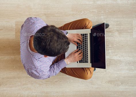 Top view of man sitting on the floor and working with a laptop by vlad_star. Top view of young man sitting on the floor and working with a laptop#man, #sitting, #Top, #view Human Back, Food Photography Tutorial, Table Top View, Diy Case, Event Flyer Templates, Man Sitting, Person Sitting, Art Chair, Happy Design