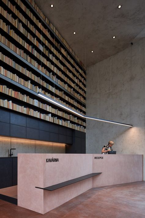 A reception desk was constructed from pink concrete. Event Venue Design, Lobby Lighting, 2023 Picture, Glass Light Fixture, Gothic Church, Religious Architecture, Gothic Design, Concrete Tiles, Hanging Light Fixtures