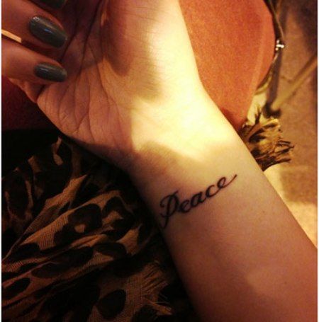 Word Peace Tattoo Peace Tattoos For Women, Believe Wrist Tattoo, Love Wrist Tattoo, Wrist Tattoos Words, Peace Sign Tattoos, Peace Tattoo, Peace Tattoos, Meaningful Wrist Tattoos, Word Tattoo