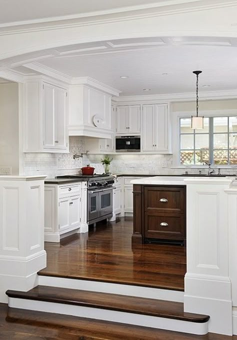 I love the steps up into the kitchen, it gives the space a dramatic flair. I also like the contrast with the white and dark wood. Crown molding is definitely a plus. Half Wall Kitchen, Room Off Kitchen, Wood Floor Kitchen, Addition Ideas, Sunken Living Room, Kabinet Dapur, Grey Kitchens, Daily 5, Family Room Design