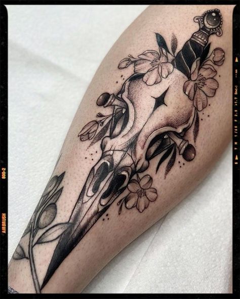 Gothic Inner Arm Tattoo, Raven Skull And Flowers Tattoo, Raven Skull Drawing Tattoo Ideas, Raven Shin Tattoo, Horror Shin Tattoo, Gothic Color Tattoo, Dagger Through Skull Tattoo, Occult Tattoo Designs, Woman Shin Tattoo