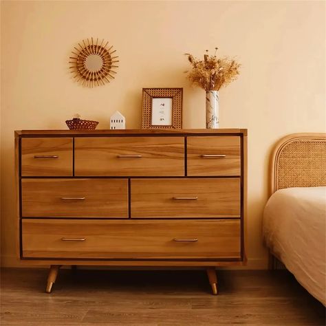 You will be charmed by the richness of its raw teak wood, which will bring a warm note to your room. Its authentic and modern character will easily fit with the style of your decor. Much more than a storage unit, this chest of drawers is a new focal point for your room.It is composed of 6 drawers, which can help you to organise your home. Its vintage look is characterised by the brass tipped, slanted feet.Inspired by vintage Scandinavian design, this raw solid teak chest of drawers will give you Mid Century Dresser Decor, Scandinavian Bedroom Dresser, Chest Drawer Decor Ideas Bedroom, Teak Interior Design, Granola House, Chest Drawer Decor Ideas, Bedroom Drawers Ideas, Modern Vintage Bedroom Ideas, Chest Of Drawers Decor