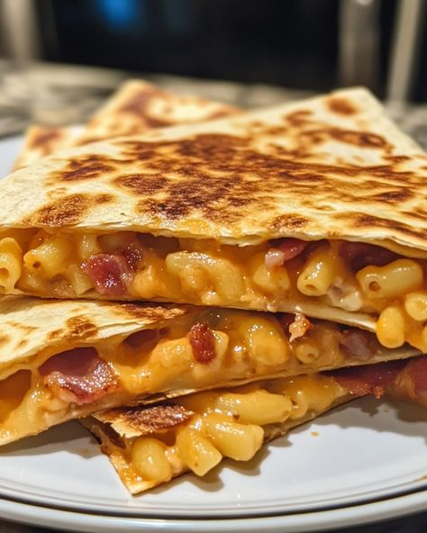 Loaded Bacon Macaroni Quesadilla 🧀🥓 🍽️ Serves: 4 ⏲️ Cooking Time: 30 minutes 🔥 Calories per serving: 600 📝 Ingredients: 2 cups cooked macaroni and cheese 8 large flour tortillas 1 cup cooked and crumbled bacon 1 cup shredded cheddar cheese 1/2 cup shredded mozzarella cheese 1/2 cup sour cream (for serving) 2 tbsp butter, for frying 1/4 cup chopped green onions (optional garnish) 1/4 tsp garlic powder 1/4 tsp paprika Salt and pepper to taste 👩‍🍳 Instructions: Heat a skillet over medium hea... Mac And Cheese Quesadilla, Cheesy Macaroni, Shredded Cheddar Cheese, Cheese Quesadilla, Daily Recipes, Crumbled Bacon, Flour Tortillas, Shredded Mozzarella, Daily Meals