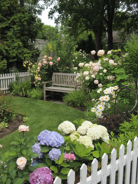 Transform your garden into a vibrant oasis like this one! Imagine relaxing on that cozy bench, surrounded by blooming beauty. Share your own garden dreams! 🌺💚 . #homeandgarden #betterhomesandgardens #homegardening #homesandgardens #homegarden #gardenhome #gardeningathome #flowers #plants #beautifulflowers Flower Beds In Front Of House, Small Flower Gardens, Backyard Flowers, Hydrangea Garden, Tranquil Retreat, English Cottage Garden, Vibrant Flowers, Garden Oasis, White Gardens